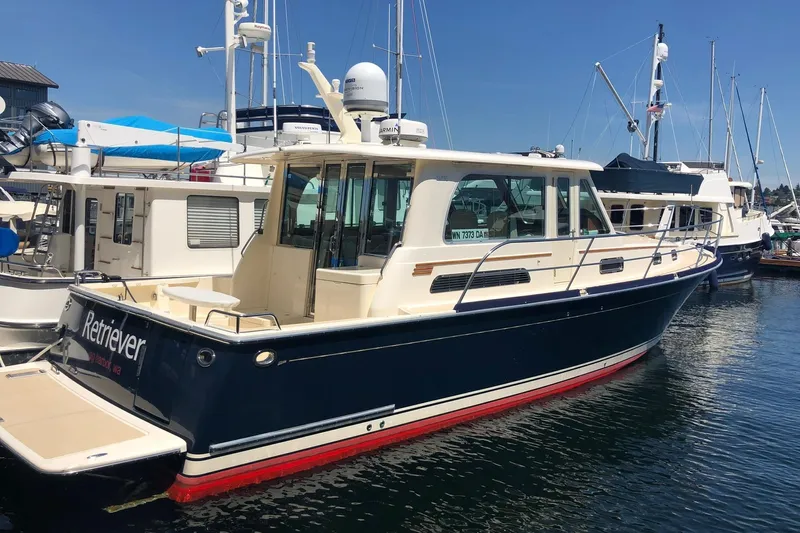  Yacht Photos Pics 2014 Sabre 42 Salon Express yacht docked in marina, blue and white exterior.