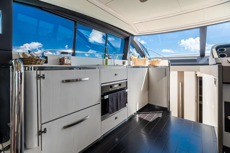 Blessed Yacht Photos Pics Luxurious kitchen interior of 2020 Azimut AZ 50-Fly yacht with modern appliances and panoramic windows.