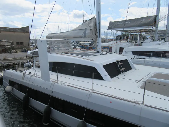 Heby Yacht Photos Pics 2023 Catana OC 50 catamaran docked at marina, featuring sleek design and modern sails.