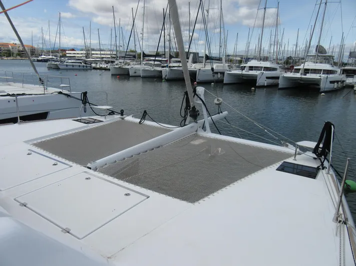Heby Yacht Photos Pics 2023 Catana OC 50 catamaran docked in marina, showcasing spacious deck and netting.