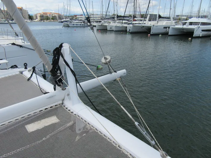 Heby Yacht Photos Pics 2023 Catana OC 50 catamaran docked in marina, featuring netted deck and rigging.