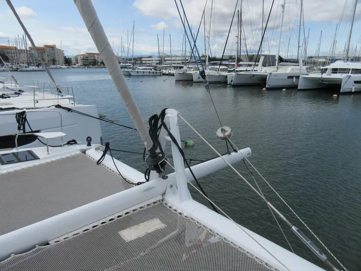 Heby Yacht Photos Pics 2023 Catana OC 50 catamaran docked in a marina, surrounded by sailboats.