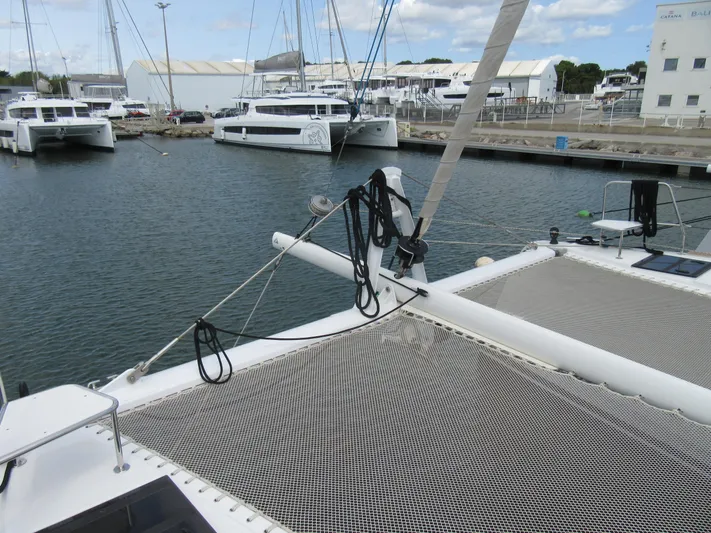 Heby Yacht Photos Pics 2023 Catana OC 50 catamaran docked in marina, showcasing deck and netting.