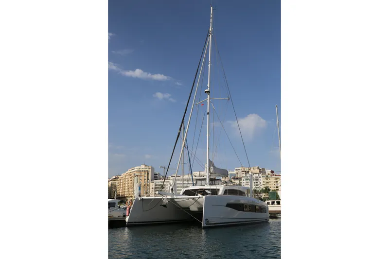 Heby Yacht Photos Pics 2023 Catana OC 50 catamaran docked in a marina under a clear blue sky.