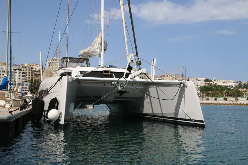 Heby Yacht Photos Pics 2023 Catana OC 50 catamaran docked in a marina with cityscape background.