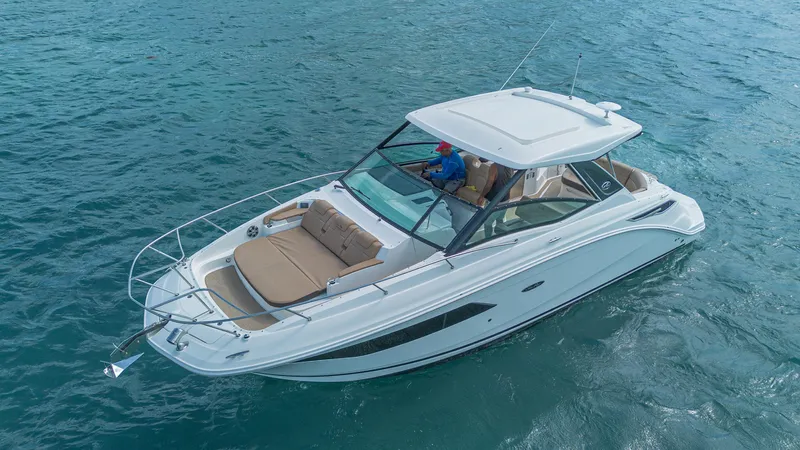 White Kraken Yacht Photos Pics 2023 Sea Ray Sundancer 320 cruising on open water, showcasing sleek design and luxury features.