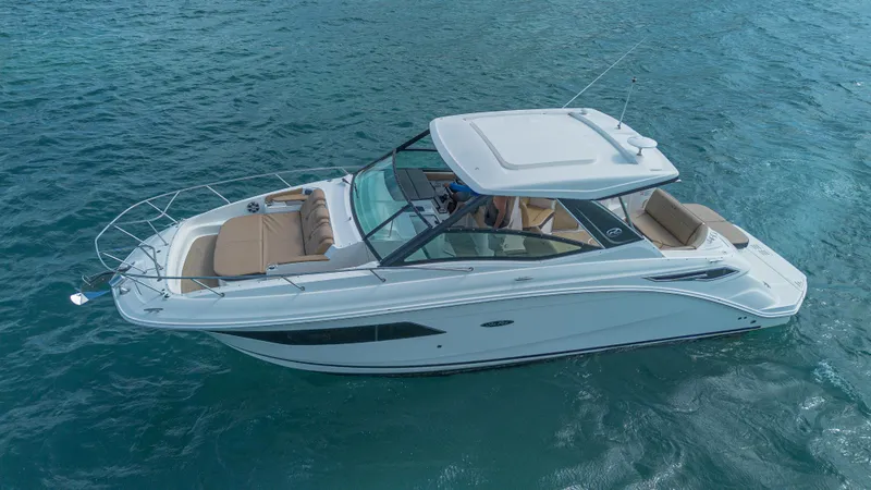 White Kraken Yacht Photos Pics 2023 Sea Ray Sundancer 320 cruising on clear blue water.