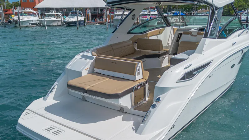 White Kraken Yacht Photos Pics 2023 Sea Ray Sundancer 320 boat with spacious seating on clear blue water.