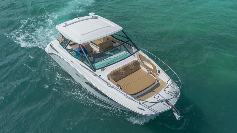 White Kraken Yacht Photos Pics 2023 Sea Ray Sundancer 320 cruising on clear blue water.