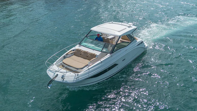 White Kraken Yacht Photos Pics 2023 Sea Ray Sundancer 320 cruising on clear blue water.