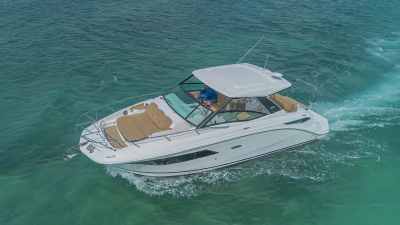 White Kraken Yacht Photos Pics 2023 Sea Ray Sundancer 320 cruising on clear blue water.