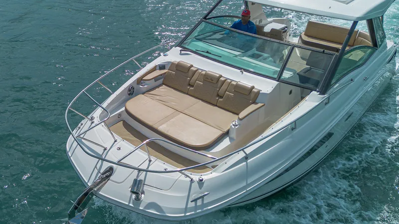 White Kraken Yacht Photos Pics 2023 Sea Ray Sundancer 320 cruising on clear blue water.