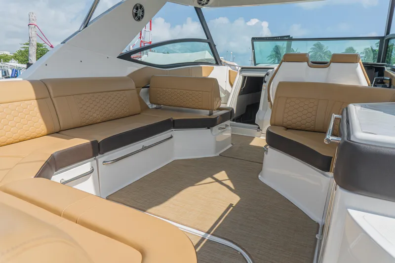 White Kraken Yacht Photos Pics 2023 Sea Ray Sundancer 320 interior with luxurious tan seating and modern design.
