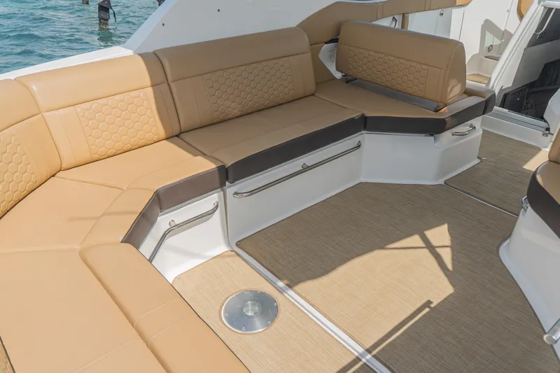White Kraken Yacht Photos Pics 2023 Sea Ray Sundancer 320 interior with tan seating and elegant design.