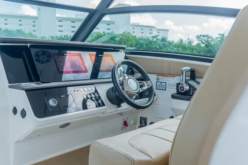 White Kraken Yacht Photos Pics 2023 Sea Ray Sundancer 320 helm with modern controls and navigation screens.