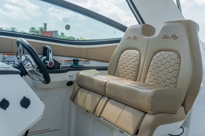 White Kraken Yacht Photos Pics 2023 Sea Ray Sundancer 320 helm with luxurious beige seating and modern controls.