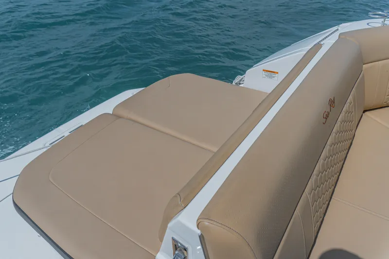 White Kraken Yacht Photos Pics 2023 Sea Ray Sundancer 320 boat with beige seating, on blue water.