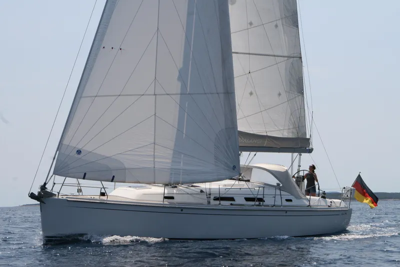  Yacht Photos Pics 2006 Hanse 370 sailboat on open water with German flag, sails fully raised.