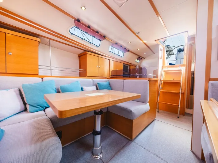  Yacht Photos Pics Interior of 2006 Hanse 370 yacht with cozy seating and wooden finishes.
