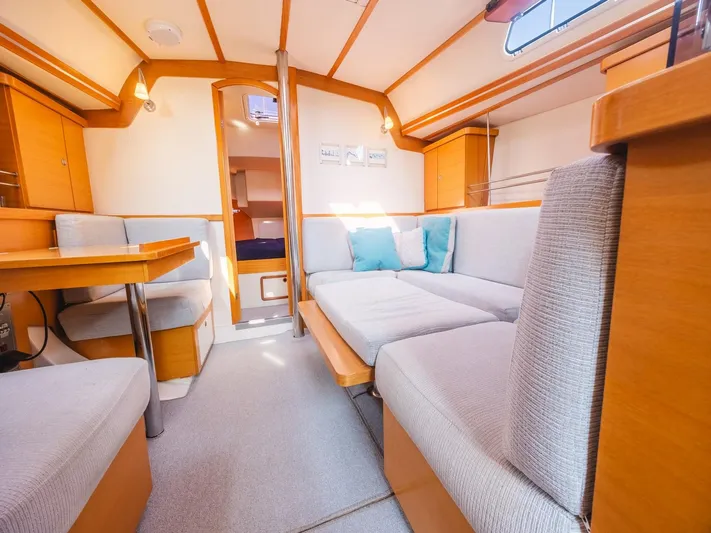  Yacht Photos Pics Interior of 2006 Hanse 370 yacht with cozy seating and wooden accents.