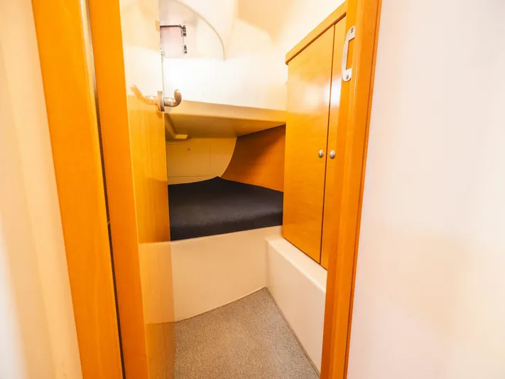  Yacht Photos Pics 2006 Hanse 370 yacht interior cabin with wooden cabinetry and cozy sleeping area.