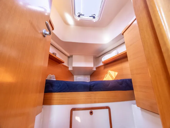  Yacht Photos Pics Cozy cabin interior of 2006 Hanse 370 sailboat with wooden finish and skylight.
