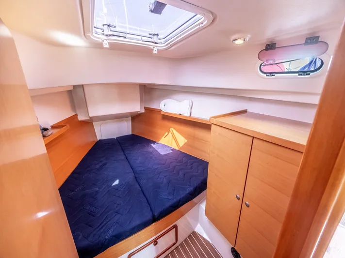  Yacht Photos Pics Cozy cabin interior of 2006 Hanse 370 yacht with wooden furnishings and skylight.
