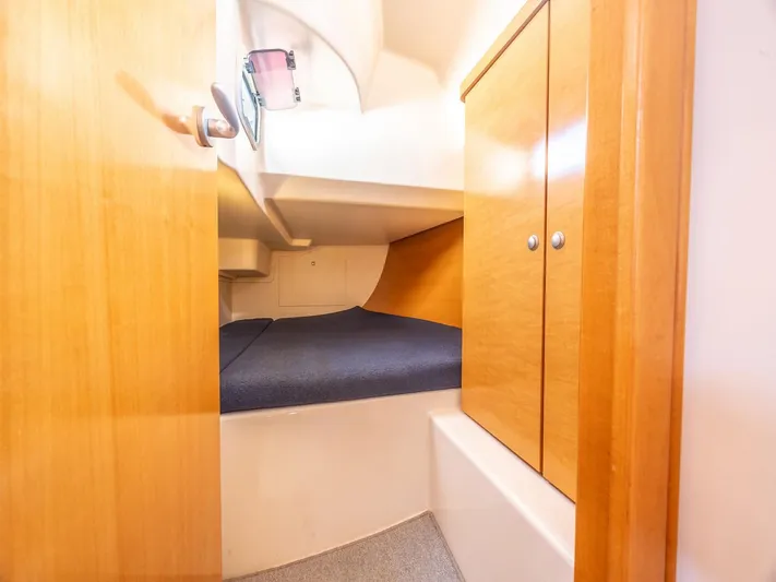  Yacht Photos Pics 2006 Hanse 370 yacht cabin interior with wooden cabinets and cozy sleeping area.