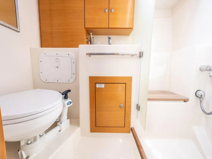  Yacht Photos Pics Compact bathroom in a 2006 Hanse 370 yacht, featuring a toilet, sink, and shower area.