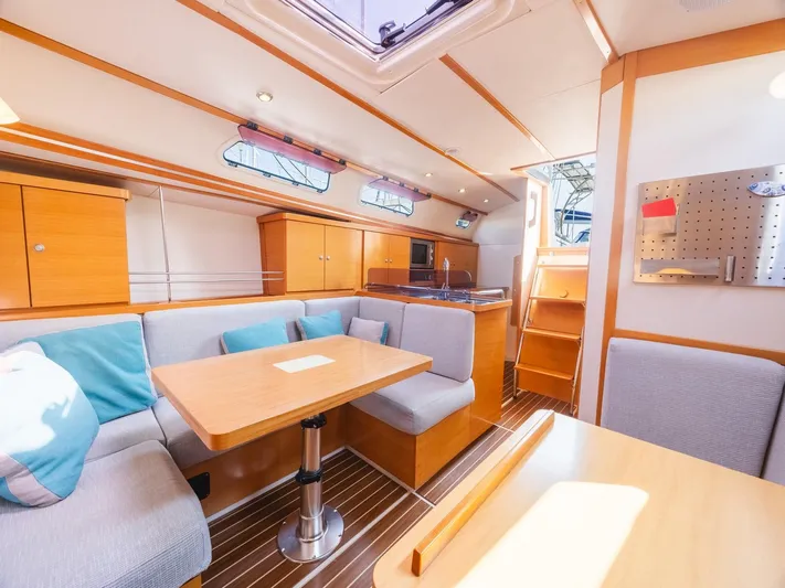 Yacht Photos Pics Interior of a 2006 Hanse 370 yacht with modern seating and wooden finishes.