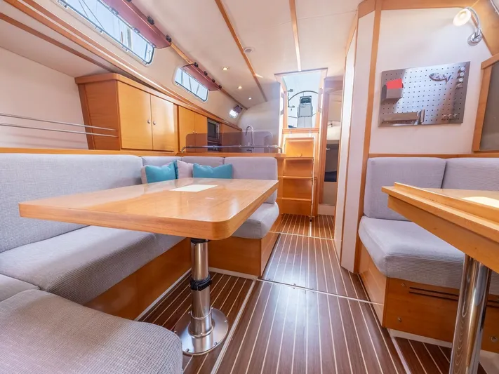  Yacht Photos Pics Spacious interior of 2006 Hanse 370 yacht with wooden furnishings and cozy seating.