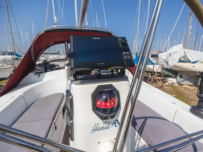  Yacht Photos Pics Cockpit of 2006 Hanse 370 sailboat with navigation equipment and compass.
