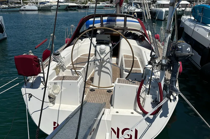  Yacht Photos Pics 2006 Hanse 370 sailboat docked in marina, featuring spacious cockpit and steering wheel.