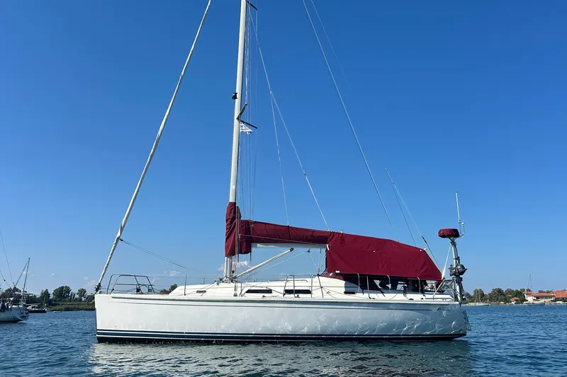  Yacht Photos Pics Sailing yacht Hanse 370, 2006 model, with red sail cover on calm water.