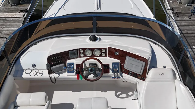 Barbie Hunter Yacht Photos Pics 2007 Regal 4080 Flybridge Sedan helm with modern controls and navigation equipment.