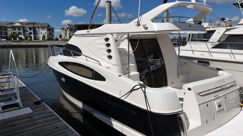 Barbie Hunter Yacht Photos Pics 2007 Regal 4080 Flybridge Sedan docked at marina under clear blue sky.