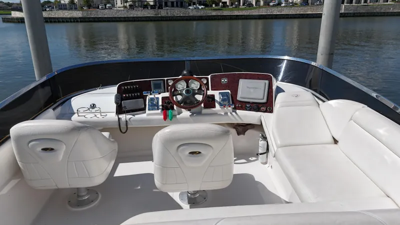 Barbie Hunter Yacht Photos Pics 2007 Regal 4080 Flybridge Sedan interior with white seating and control panel.