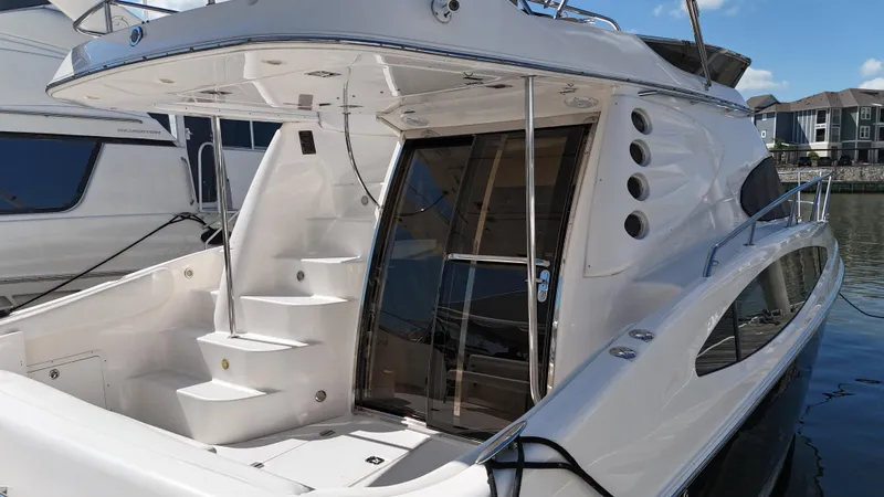 Barbie Hunter Yacht Photos Pics 2007 Regal 4080 Flybridge Sedan yacht docked, featuring sleek design and spacious deck.