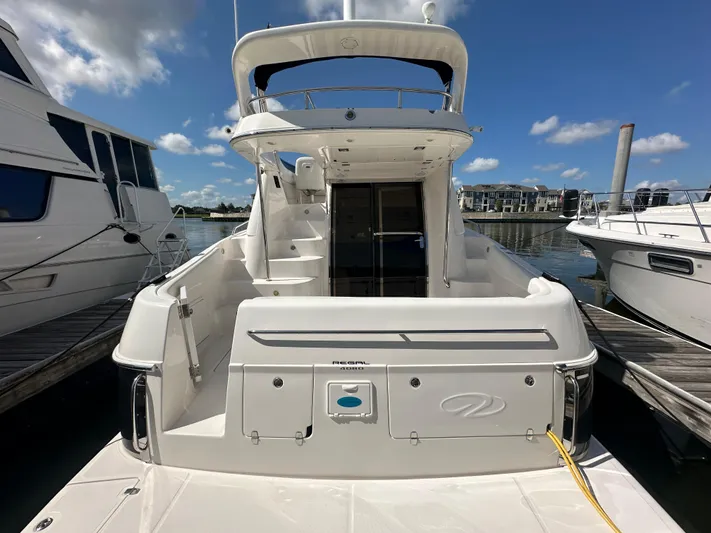 Barbie Hunter Yacht Photos Pics 2007 Regal 4080 Flybridge Sedan yacht docked under clear skies.