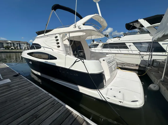 Barbie Hunter Yacht Photos Pics 2007 Regal 4080 Flybridge Sedan docked at marina under clear blue sky.