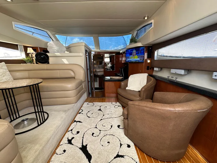 Barbie Hunter Yacht Photos Pics Luxurious interior of 2007 Regal 4080 Flybridge Sedan yacht with plush seating and elegant decor.