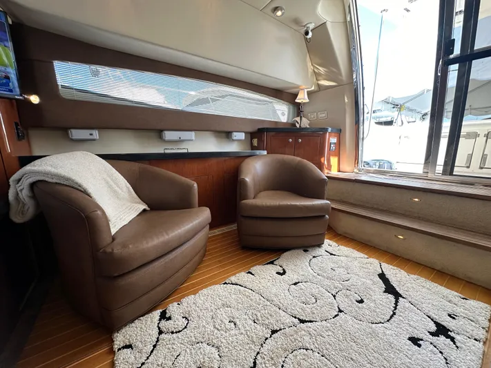 Barbie Hunter Yacht Photos Pics Luxurious interior of 2007 Regal 4080 Flybridge Sedan with leather chairs and elegant decor.