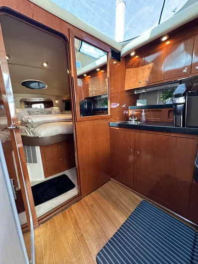 Barbie Hunter Yacht Photos Pics Luxurious interior of 2007 Regal 4080 Flybridge Sedan with wood finish and cozy cabin.