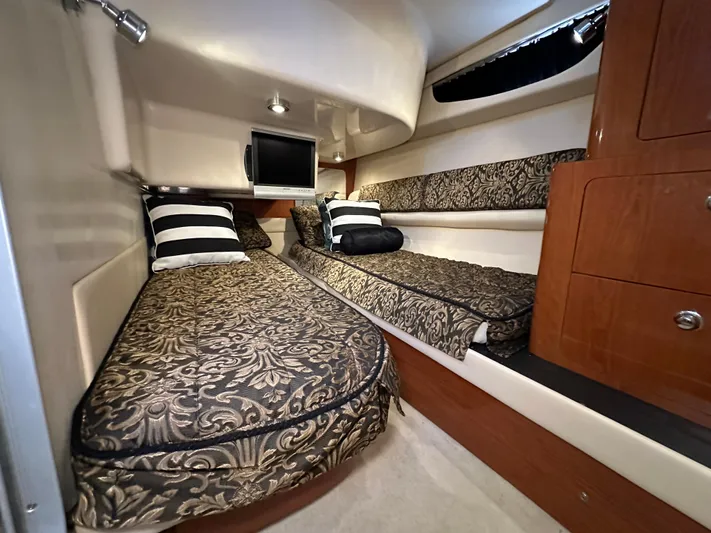 Barbie Hunter Yacht Photos Pics Luxurious cabin interior of 2007 Regal 4080 Flybridge Sedan with elegant bedding and wood accents.