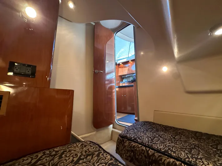 Barbie Hunter Yacht Photos Pics Interior of 2007 Regal 4080 Flybridge Sedan with twin beds and wood paneling.