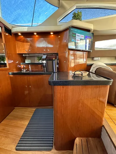 Barbie Hunter Yacht Photos Pics Luxurious interior of 2007 Regal 4080 Flybridge Sedan with modern kitchen amenities.