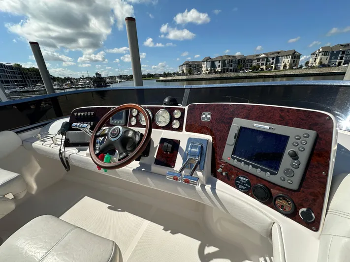 Barbie Hunter Yacht Photos Pics 2007 Regal 4080 Flybridge Sedan helm with navigation equipment and waterfront view.
