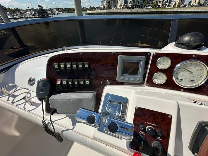 Barbie Hunter Yacht Photos Pics Control panel of 2007 Regal 4080 Flybridge Sedan with gauges and switches, docked at marina.