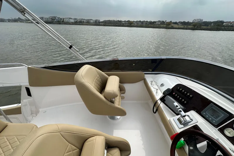 Barbie Hunter Yacht Photos Pics Regal 4080 Flybridge Sedan 2007 helm with water view.