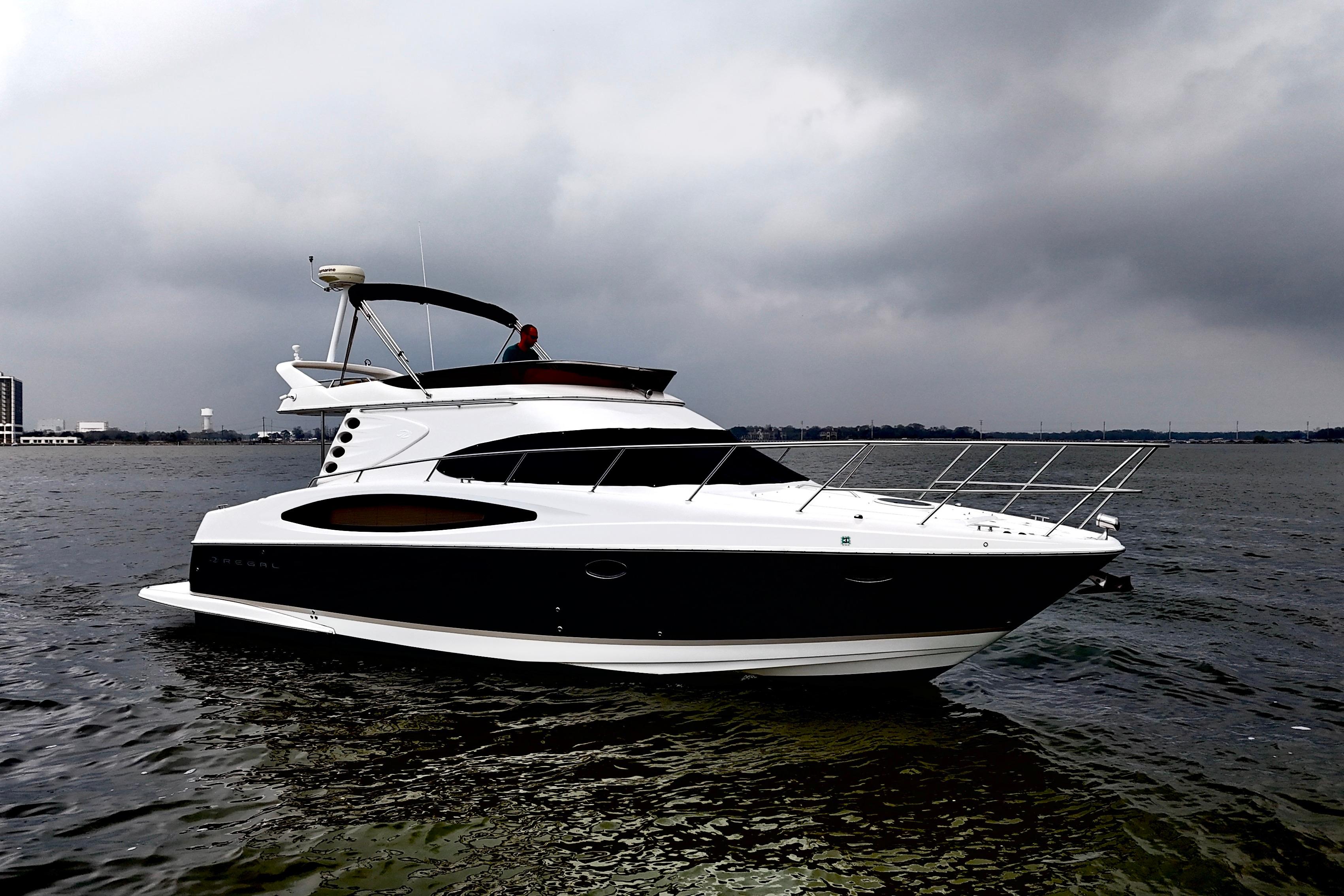 2007 Regal 4080 Flybridge Sedan on calm water under cloudy skies.